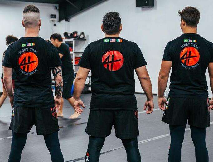 Three men in bjj training shirts.