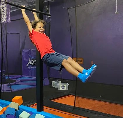Swinging-over-blocks-1 picture of girl swinging at summer camp