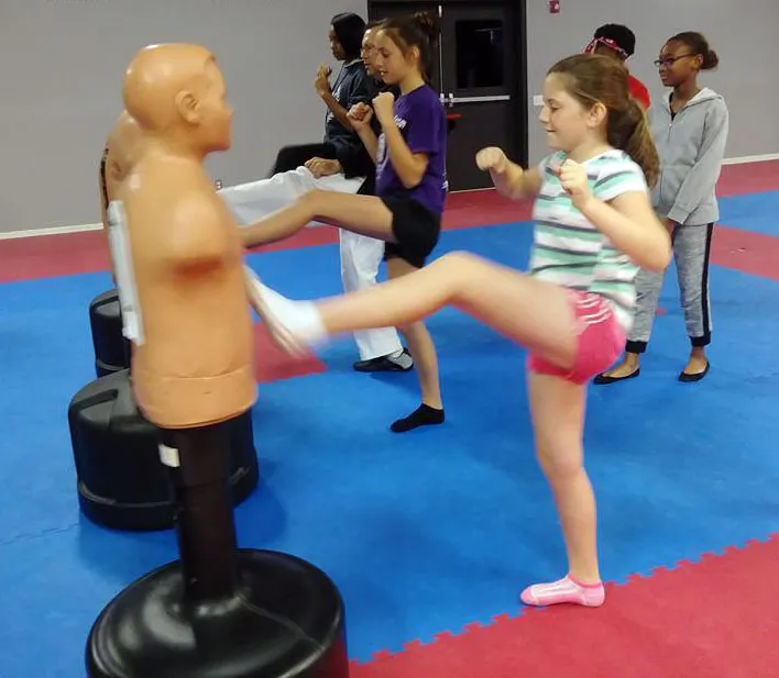 girl-front-kicks-bob-at-Unity-Martial-Arts-Academy summer camp for kids picture of girl kicking