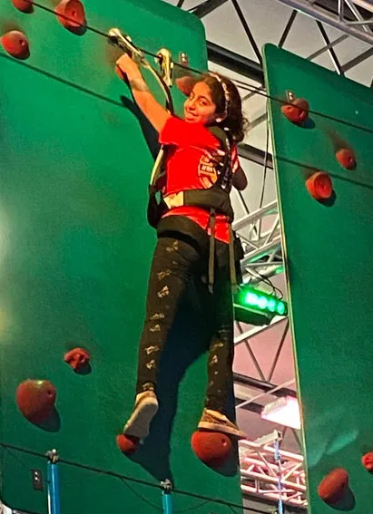 girl-on-climbing-wall picture of girl on climbing wall at summer camp