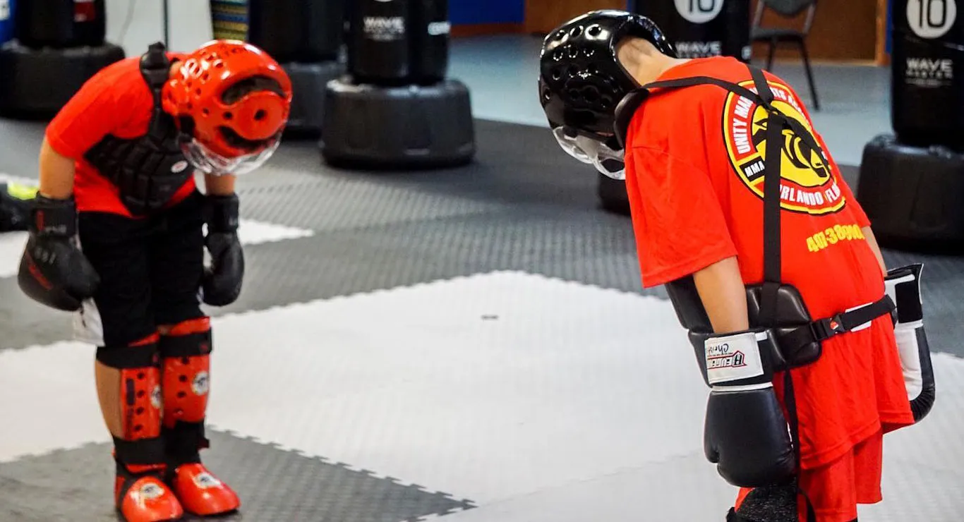 children in martial arts class bowing